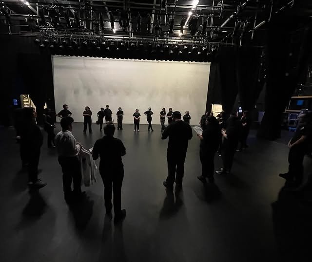 The crew circled up on stage for the post-show debrief
